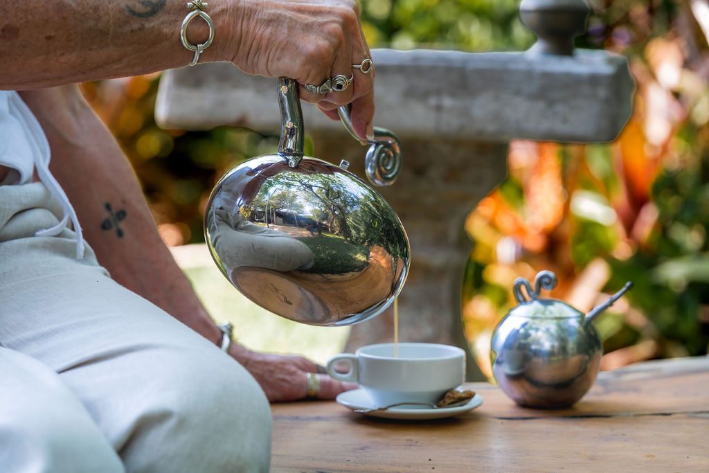 Tea being poured at a garden table